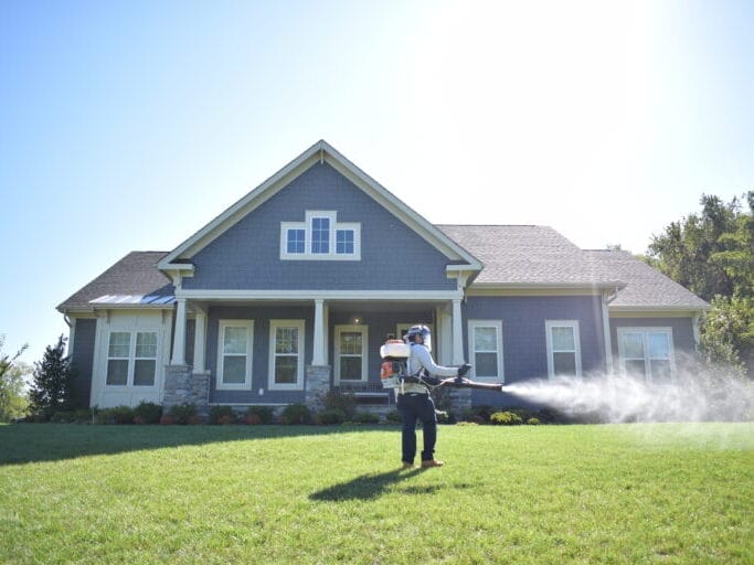 Technician Preforming Mosquito treatment tick Treatment yard